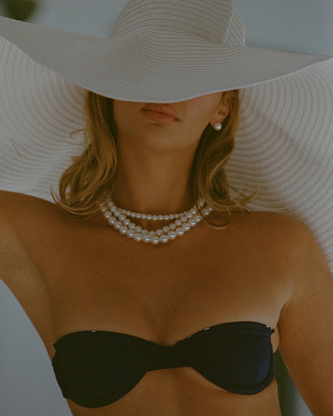 India reversible underwire bikini in matte navy, reversing to navy polka dots, offering strapless or halterneck styling with a tie-back closure.