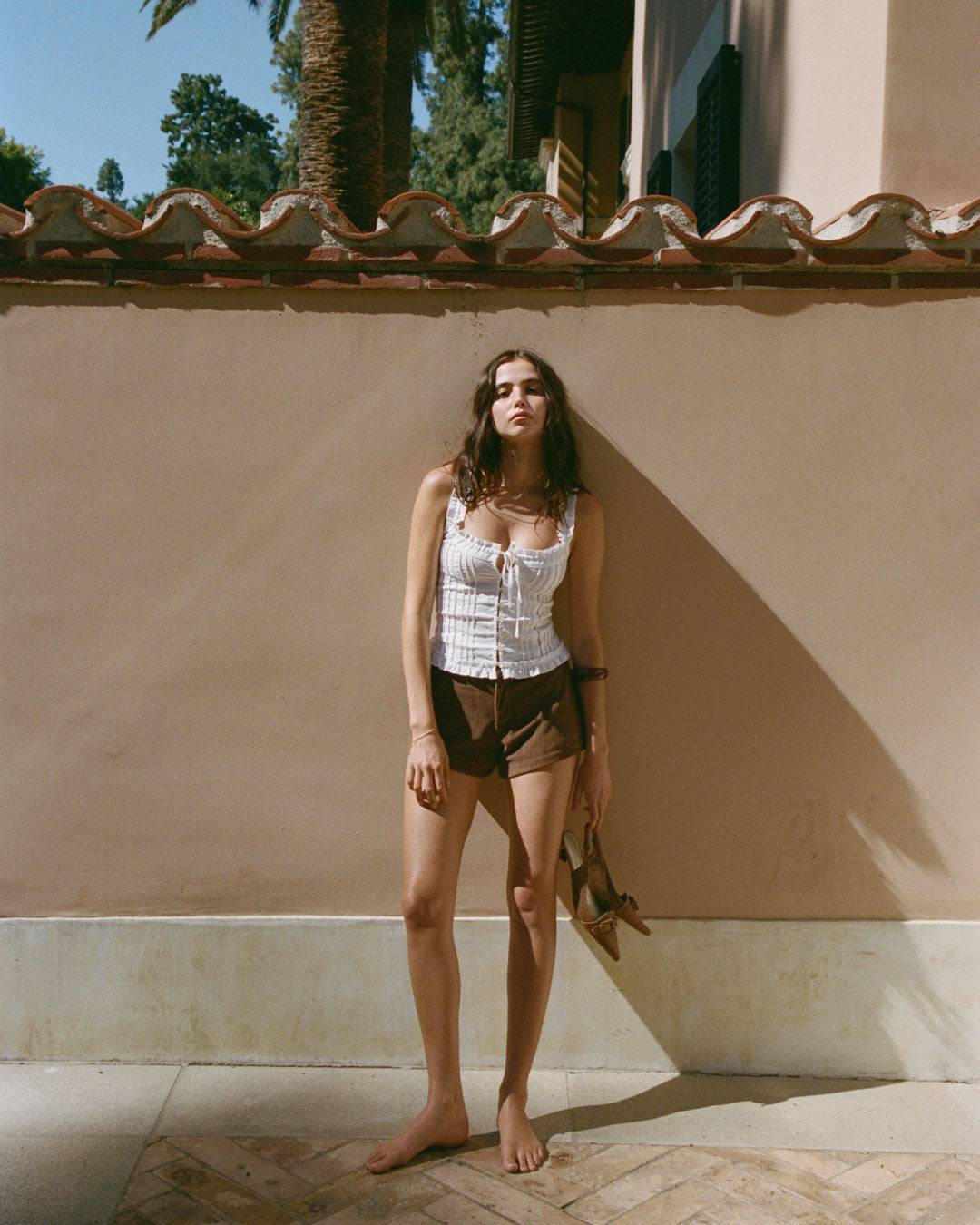 Eliza Top in Bianco white resort blouse with lace paneling, button-up front, and ruffled hem