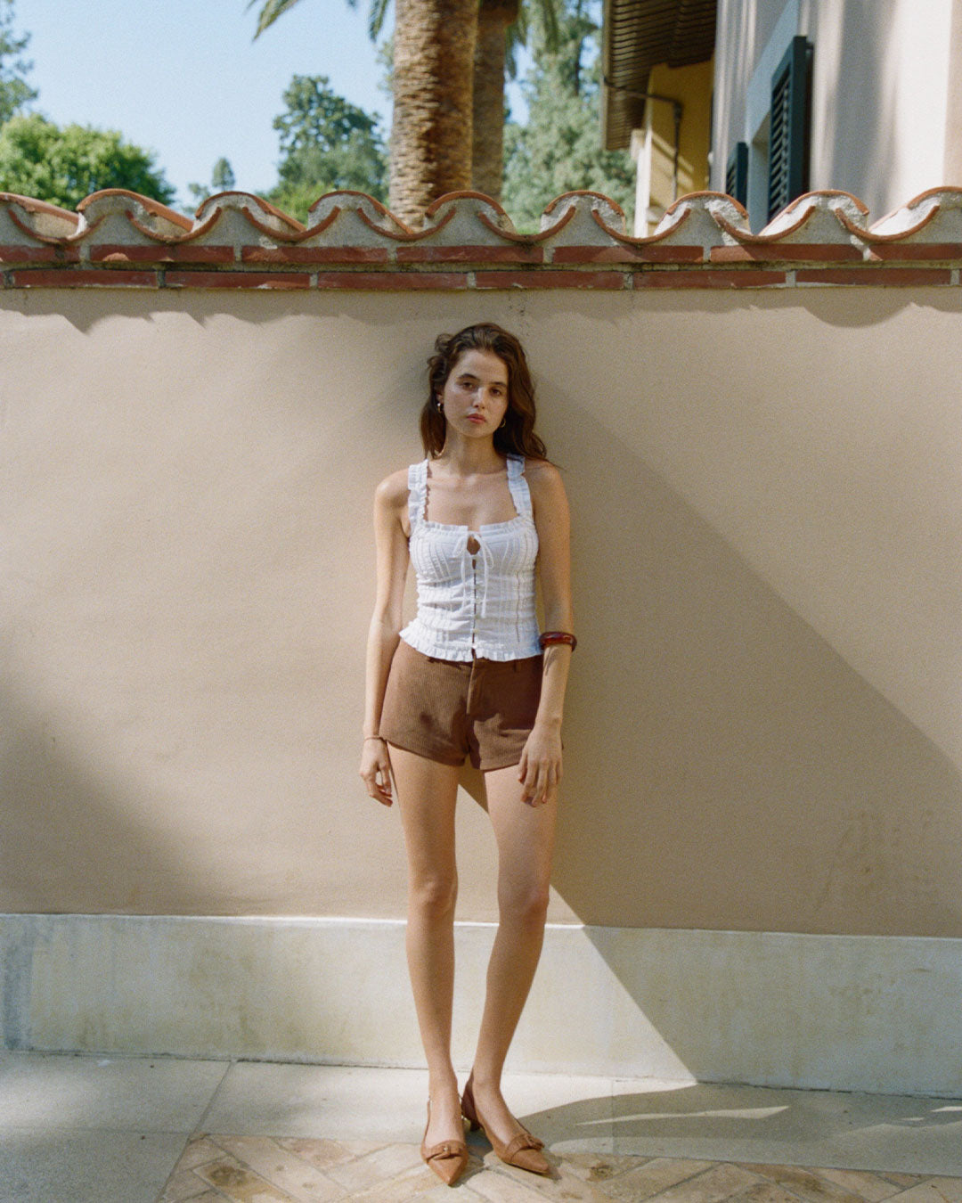 Eliza Top in Bianco white resort blouse with lace paneling, button-up front, and ruffled hem
