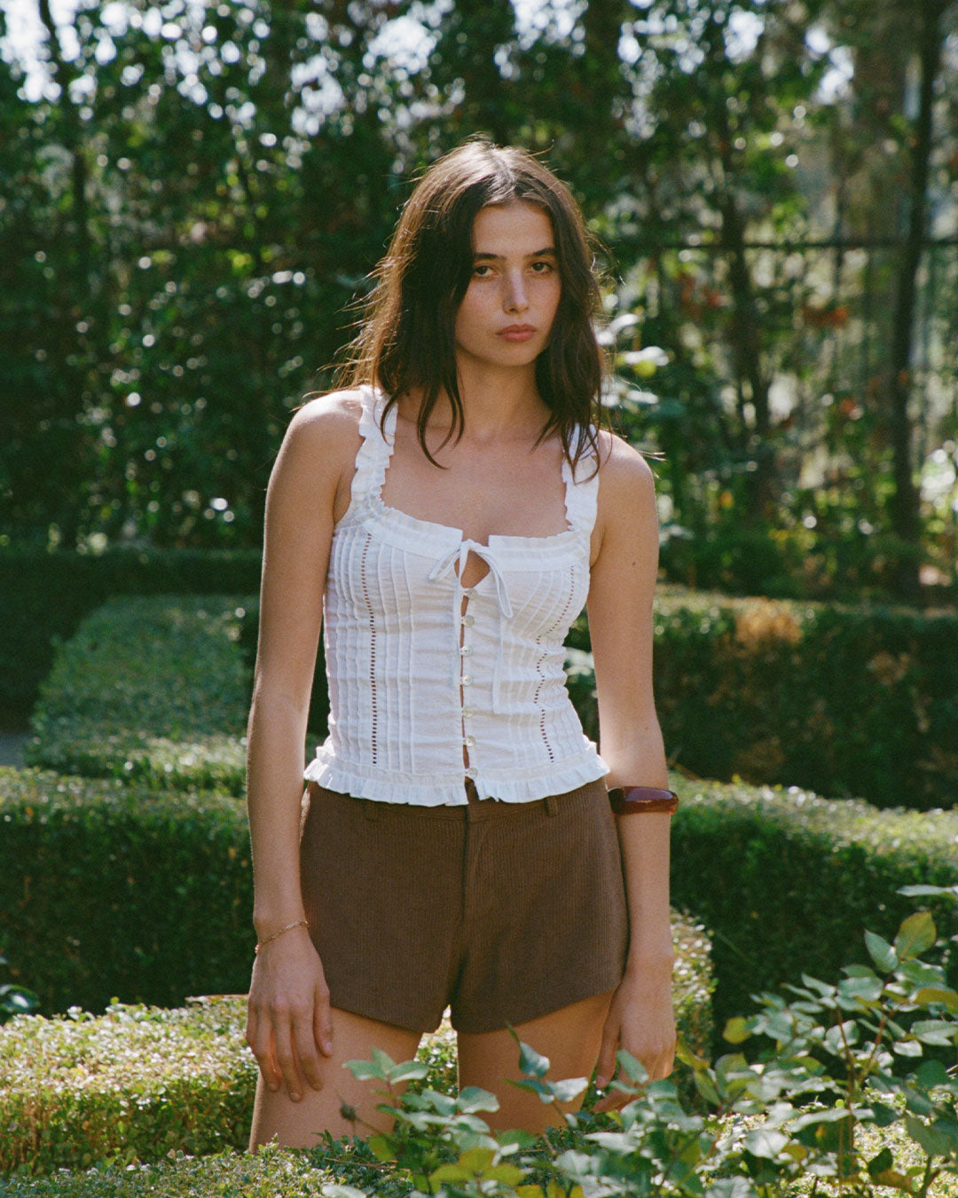 Eliza Top in Bianco white resort blouse with lace paneling, button-up front, and ruffled hem