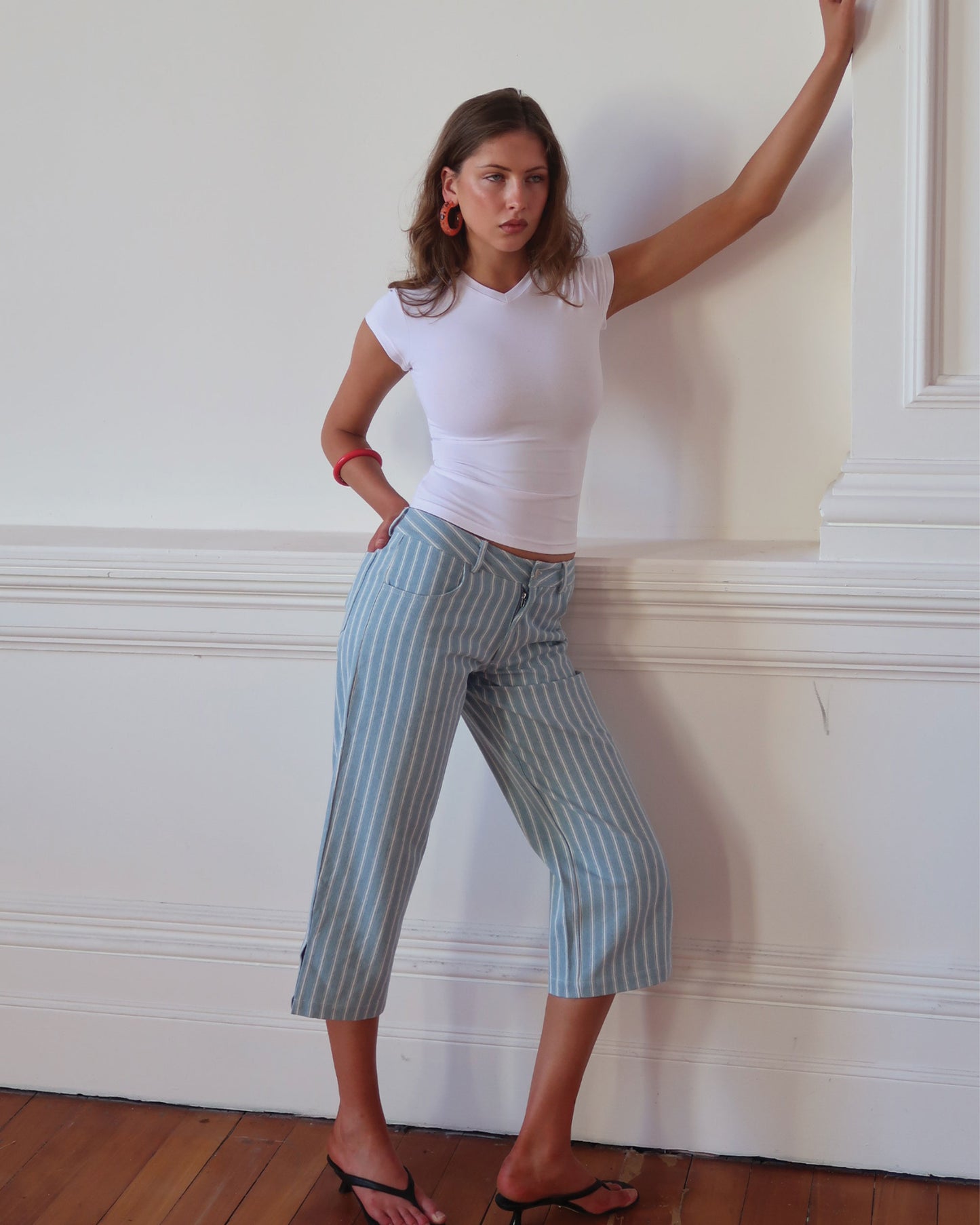 Women's low waisted pant in denim stripe featuring 3/4 length and straight leg fit. 