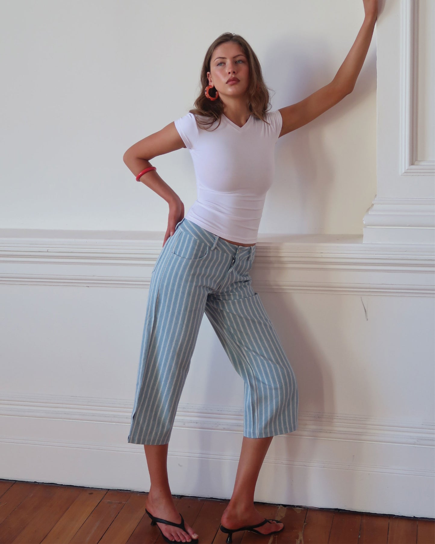 Women's low waisted pant in denim stripe featuring 3/4 length and straight leg fit. 